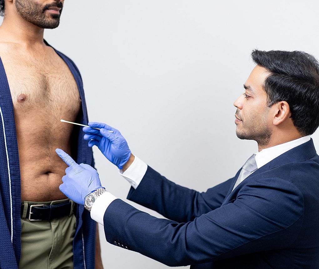 Medical examination with swab technique demonstration.