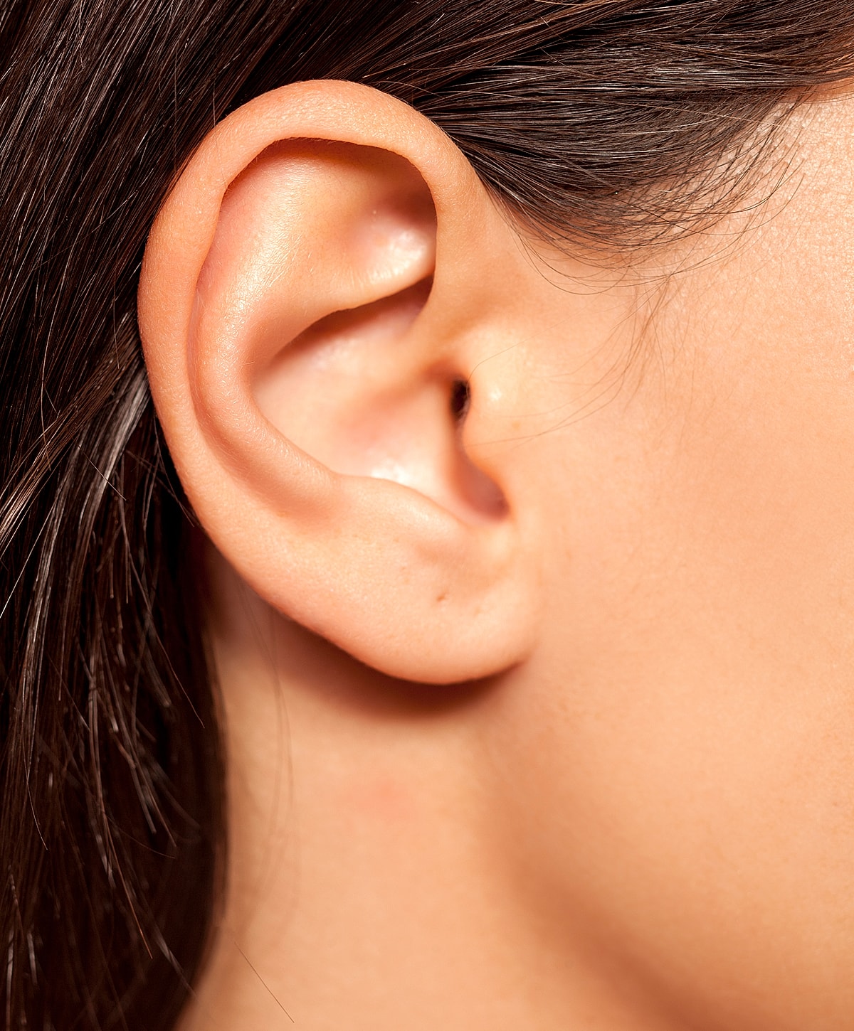 Close-up of a human ear with hair.
