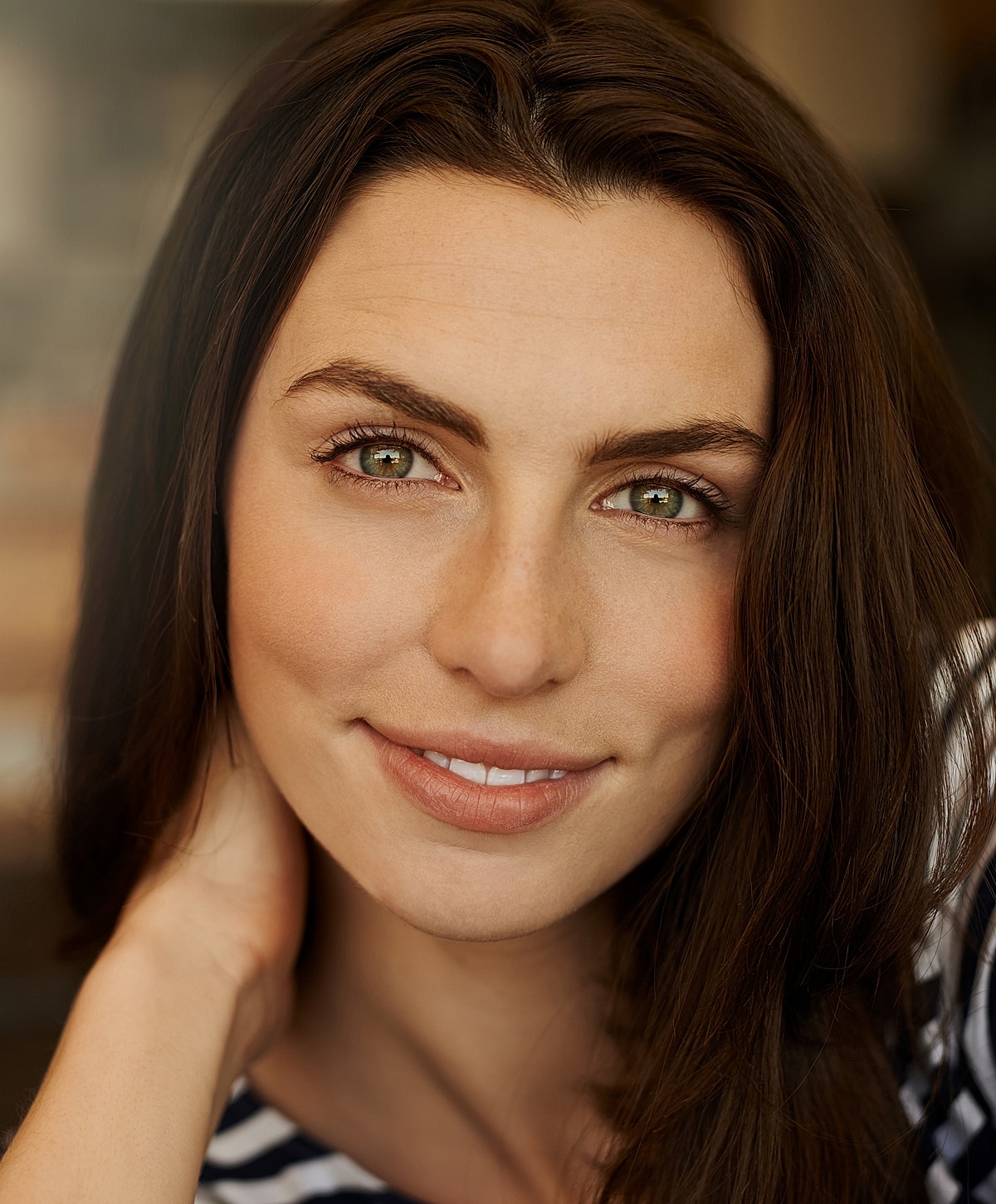 Smiling woman with long, dark hair.