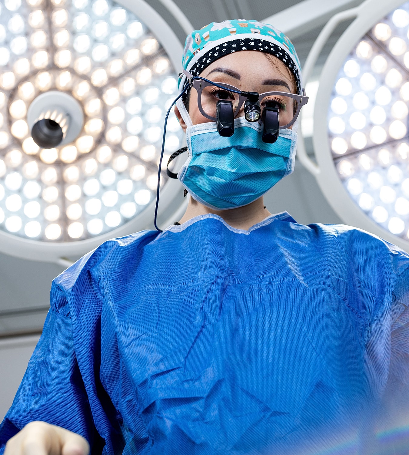 Surgeon performing a procedure in an operating room.