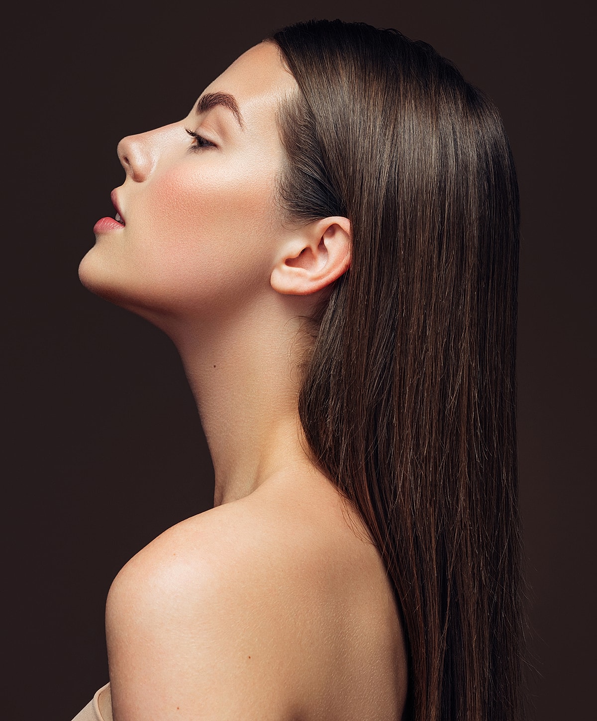Profile of a woman with long, sleek hair.