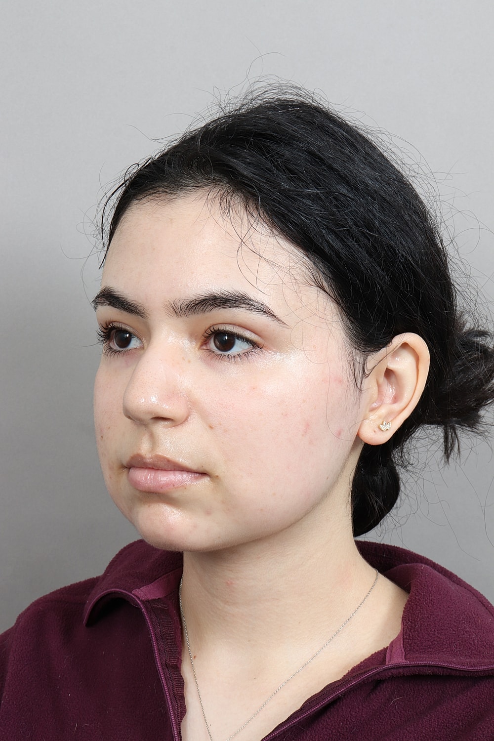 Profile view of a woman smiling.