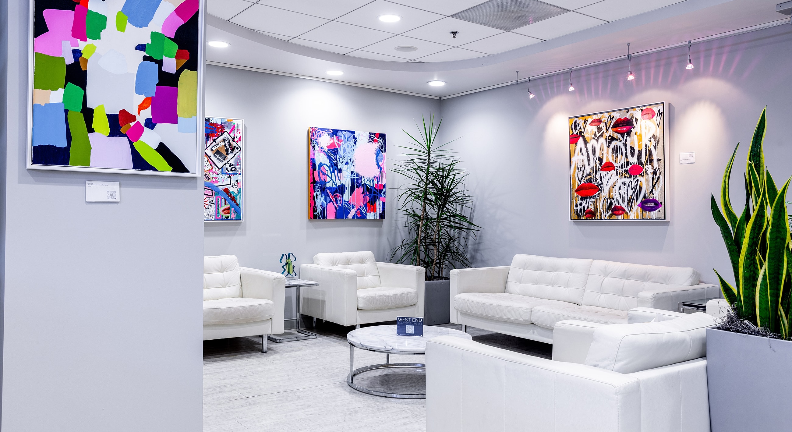 Modern waiting area with vibrant artwork and plants.