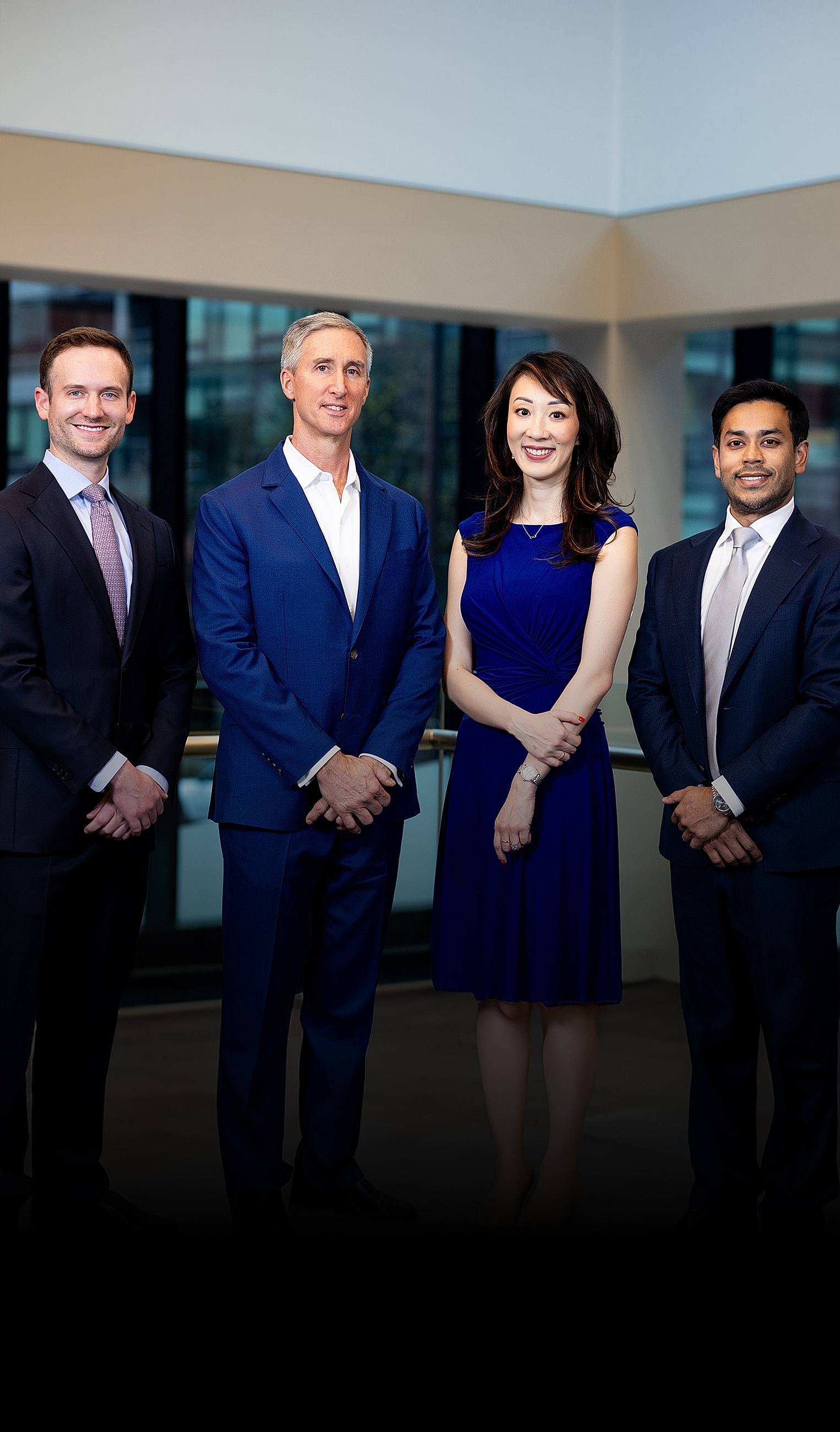 Business professionals posing in a modern office.