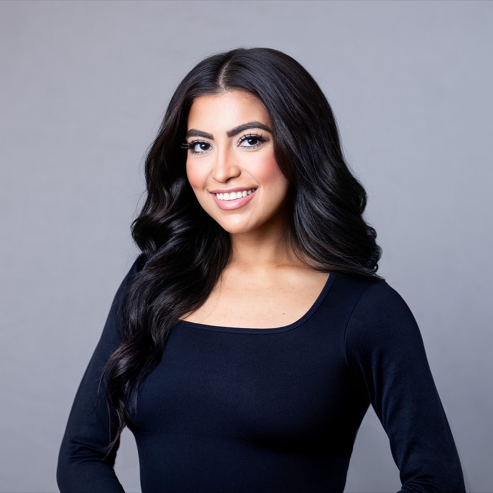 Smiling woman with long dark hair portrait.