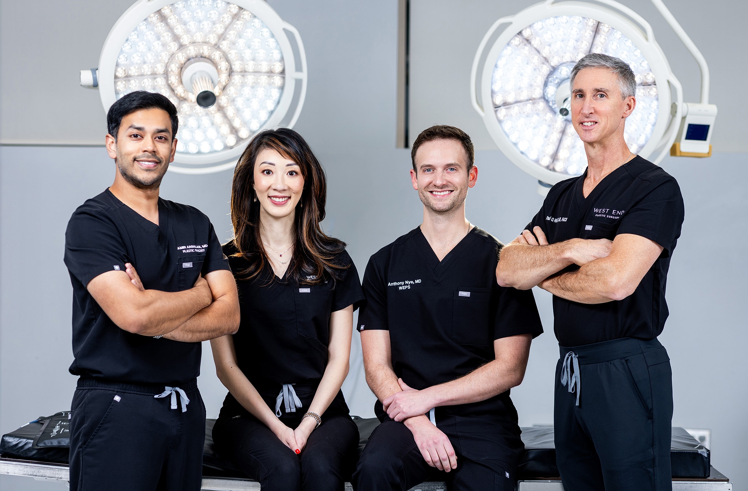 Medical team in scrubs posing for a photo.